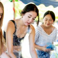 Three students tie-dying